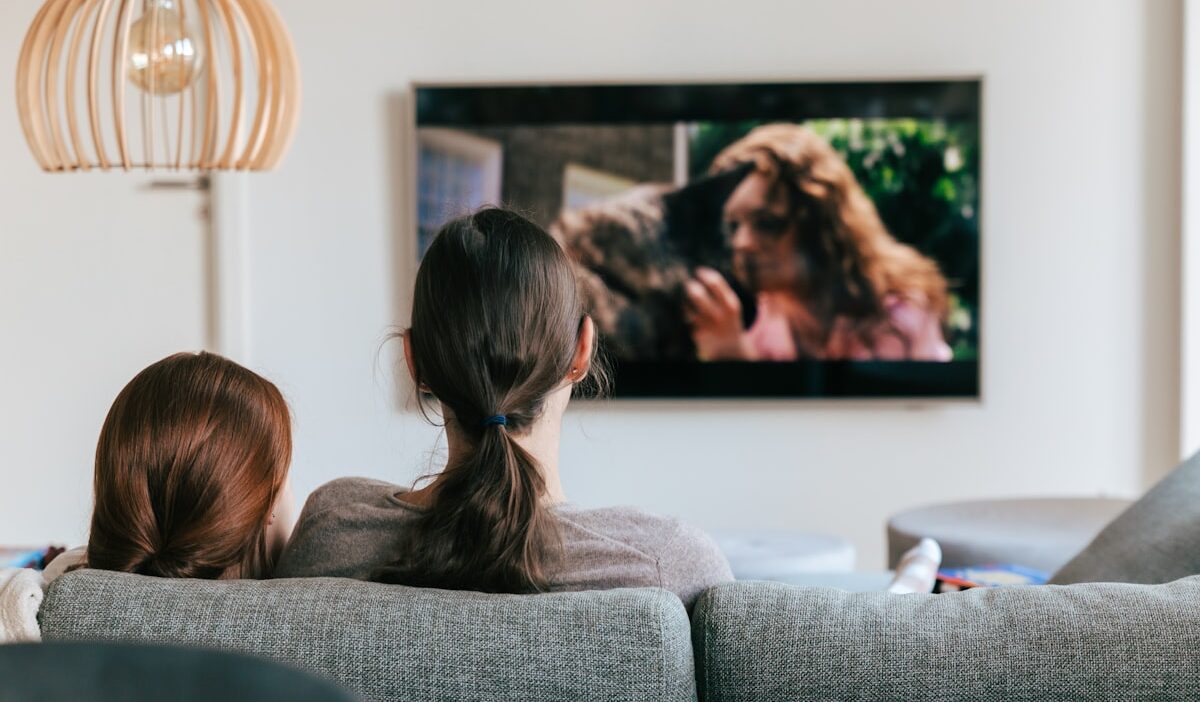 Connected TV screen displaying performance marketing funnel with attribution arrows linking streaming ads to lower funnel conversions